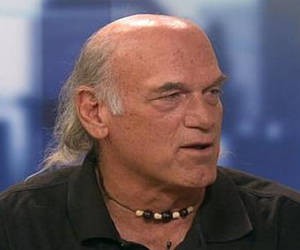 Jesse Ventura being interviewed showing long hair at back