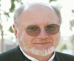 david ogden stiers wearing glasses with sort white beard