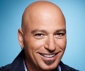 howie mandel bald head with earring and smiling